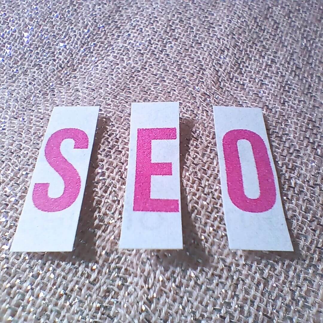 SEO spelled with letter blocks on textured surface