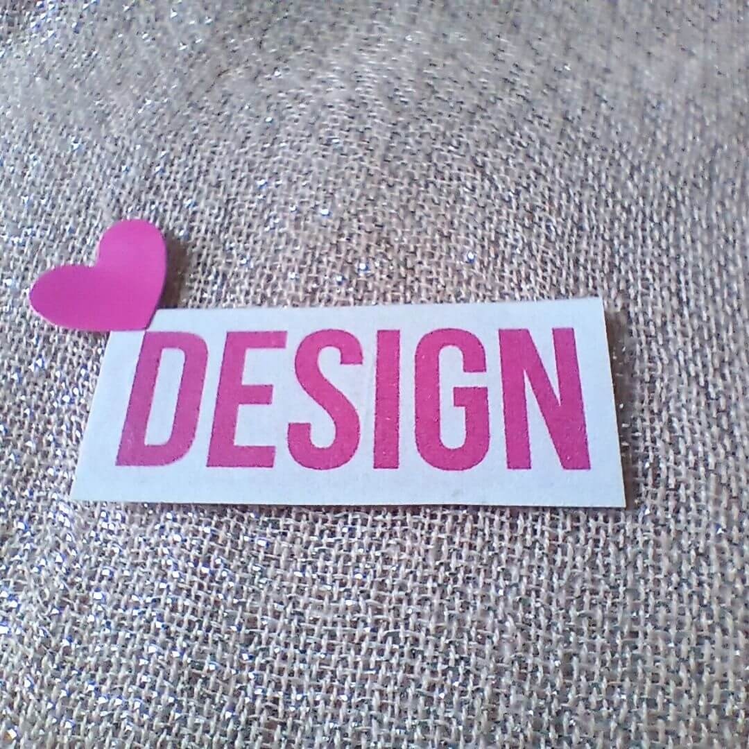 Text block spelling DESIGN on textured background