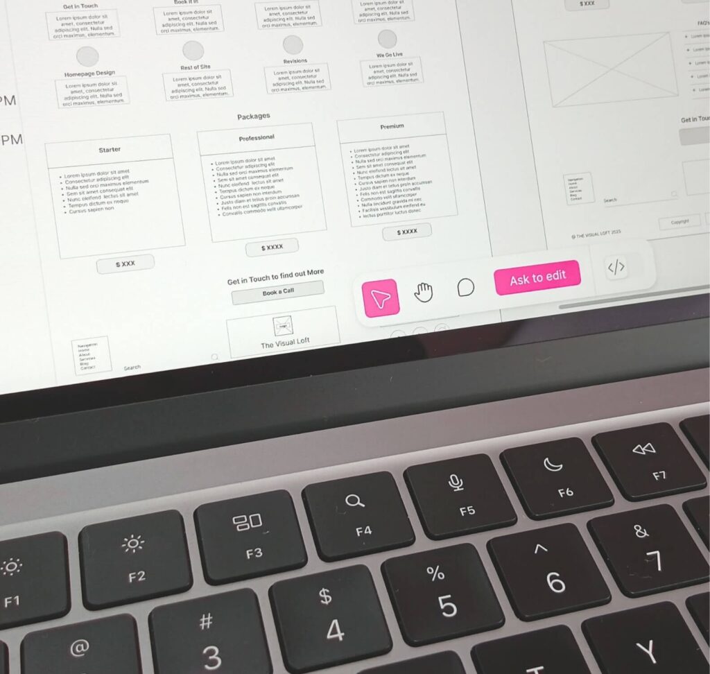 Printed wireframes on a laptop keyboard for planning website structure