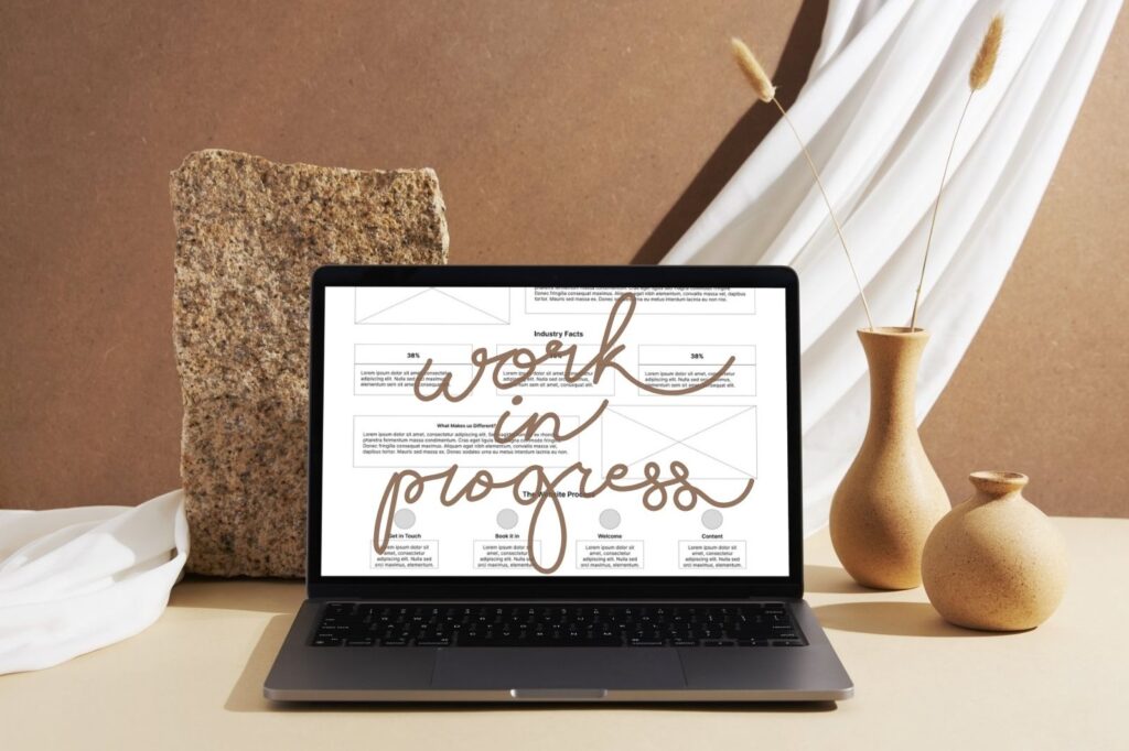 Laptop showing a wireframe layout with ‘Work in Progress’ overlay for Pixel and Scale website